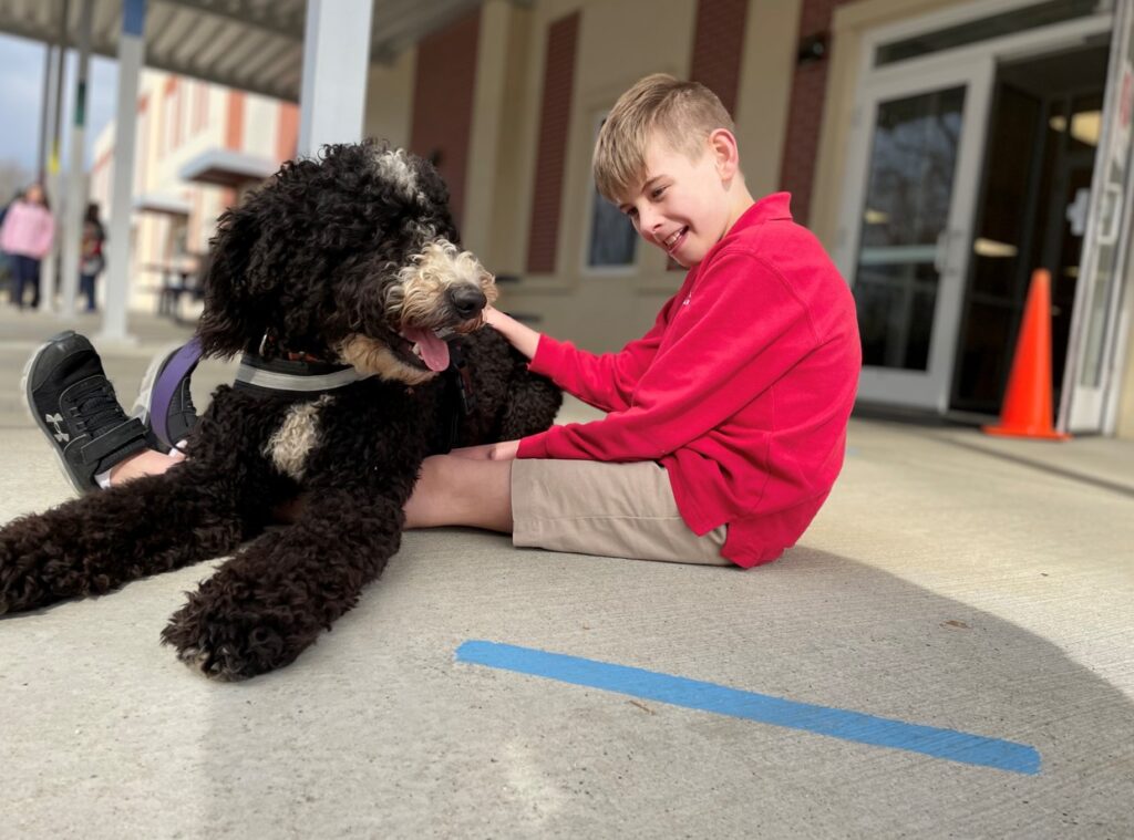 service dog with child outside school